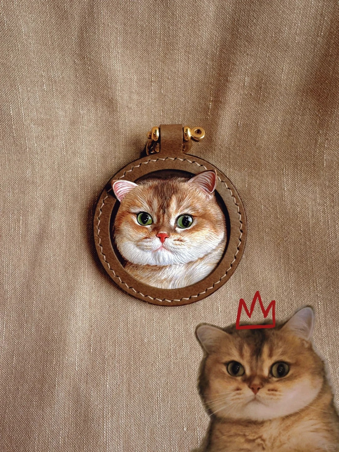 Realistic leather pet portrait charm of a British Shorthair cat in a stitched round brown frame with gold rivet, based on real photo
