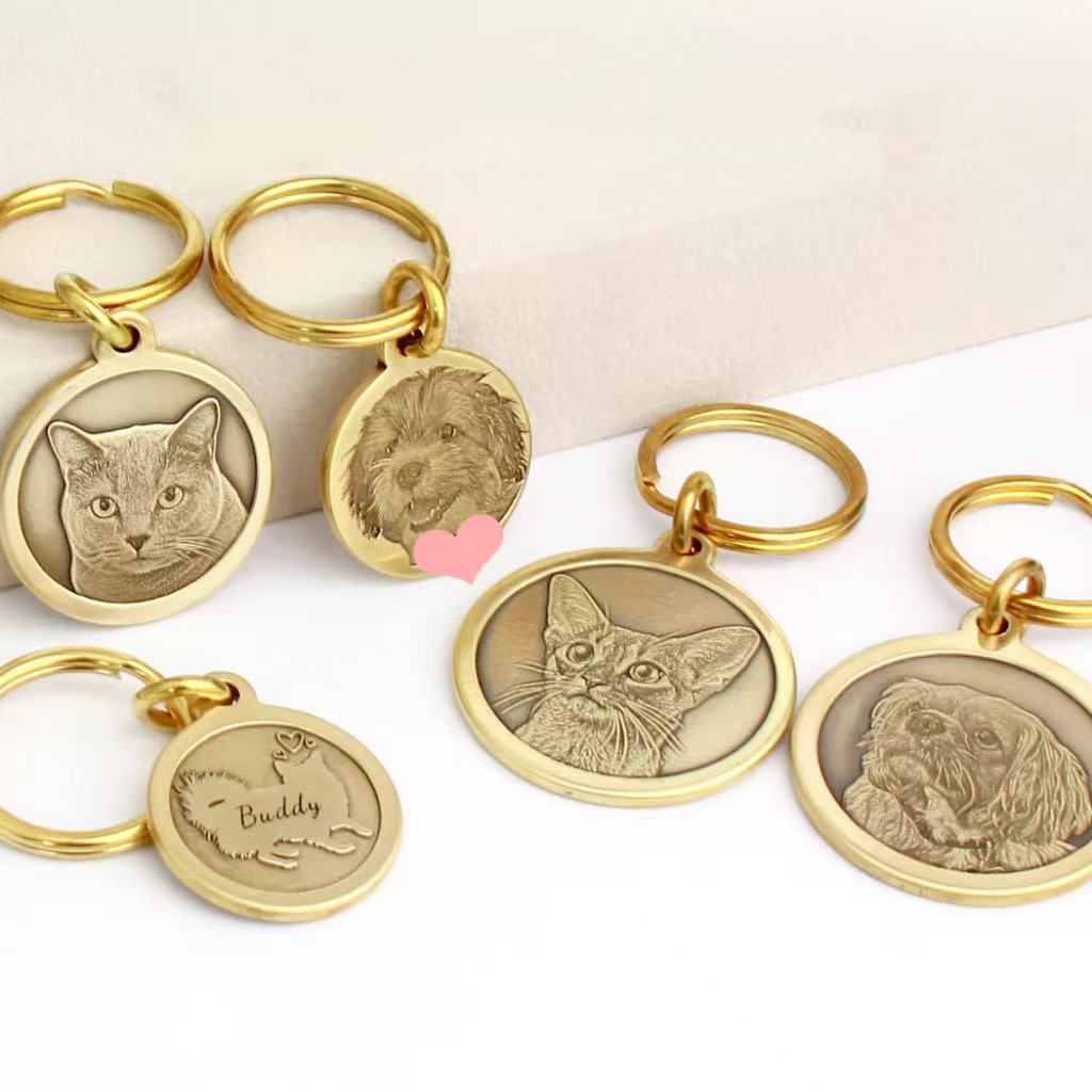 Collection of custom deep engraved round brass pet tags for cats and dogs.