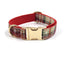 Beige and red plaid pet collar with gold buckle and red inner layer.