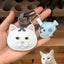 Handmade cartoon-style cat leather charm in white with blue fish accessory, crafted from goatskin leather, ersonalized from pet image