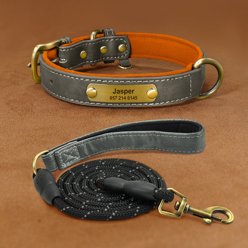 Gray PU leather dog collar with brass engraved nameplate and soft orange lining.