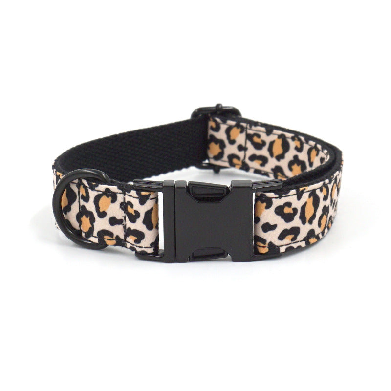 Leopard print pet collar with black metal buckle and D-ring.