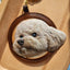 Hand-carved 3D leather portrait of a white poodle-style dog with gold keyring, ultra-realistic texture made from genuine cowhide leather