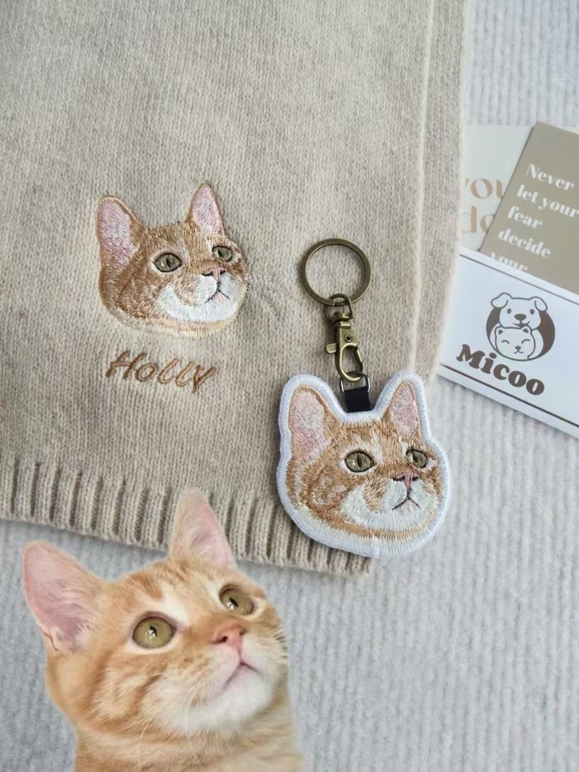 Personalized embroidered cat keychain with metal clasp, shown alongside real cat and fabric embroidery.