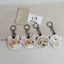 Embroidered keychain of a custom cat and dog portrait with clasp, made from uploaded pet photo.