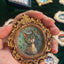 Round brown ceramic magnet on display stand, depicting oil painting
