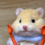 Handmade twist yarn stick of a light brown hamster holding orange spoons
