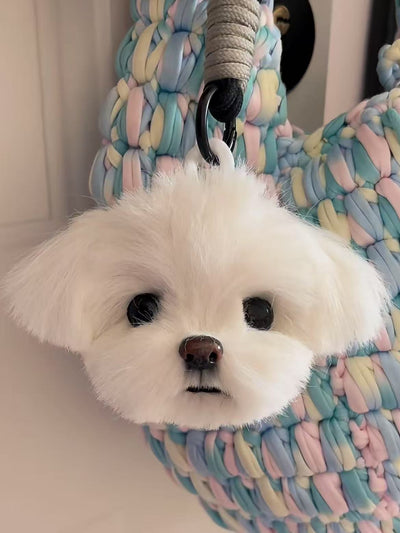 Custom twist yarn stick head of a white dog with round eyes, used as a bag charm
