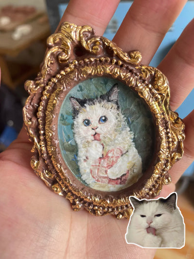 Oval brown ceramic fridge magnet with oil painting-style cat portrait