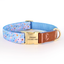 Blue floral print dog collar with personalized engraved buckle and brown webbing.