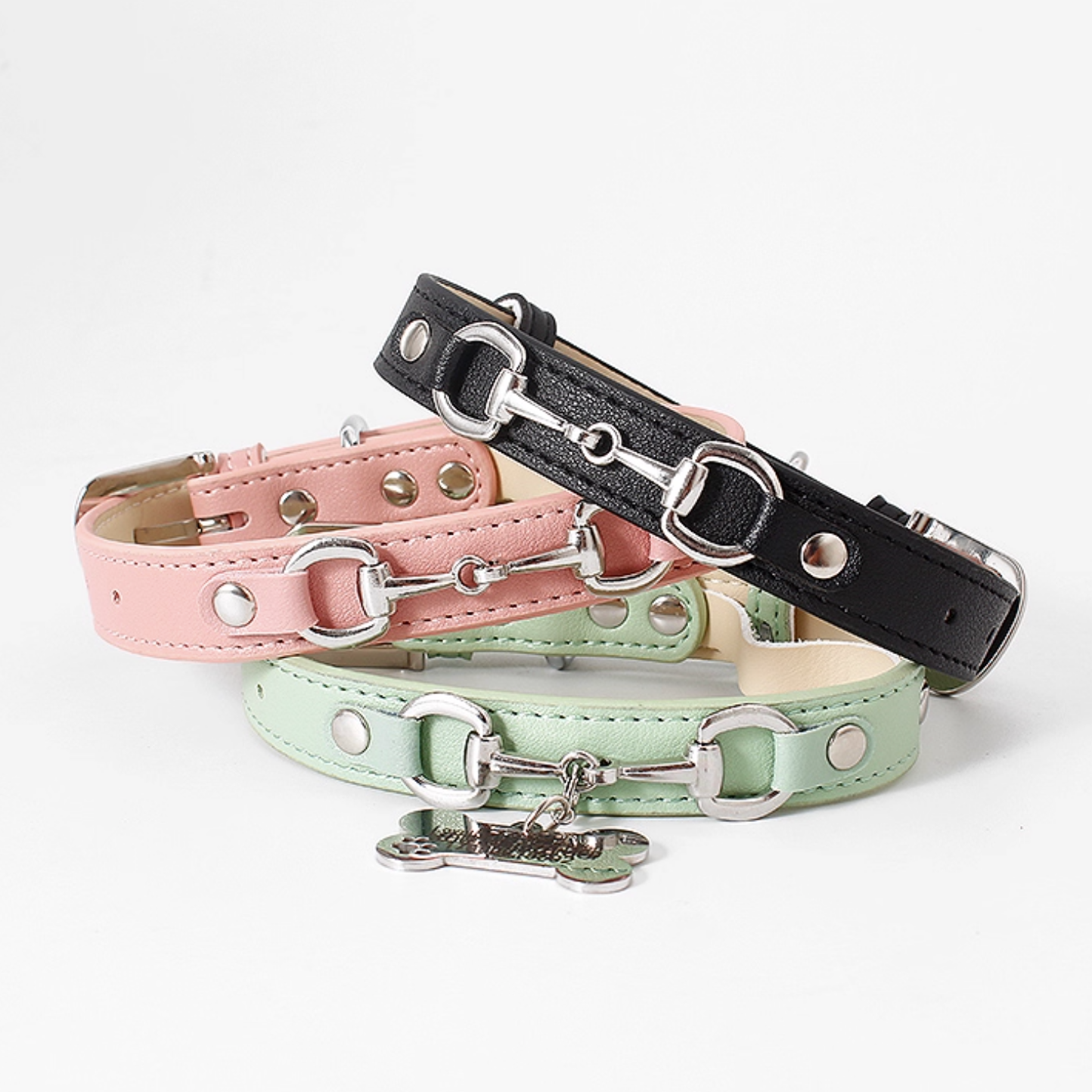 Stacked display of dog collars in black pink mint green and light blue