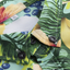 Close-up of Hawaiian shirt collar and buttons showing neat stitching and vibrant tropical print.
