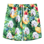 Custom dog face tropical shorts featuring banana leaves, hibiscus flowers, and green jungle print.